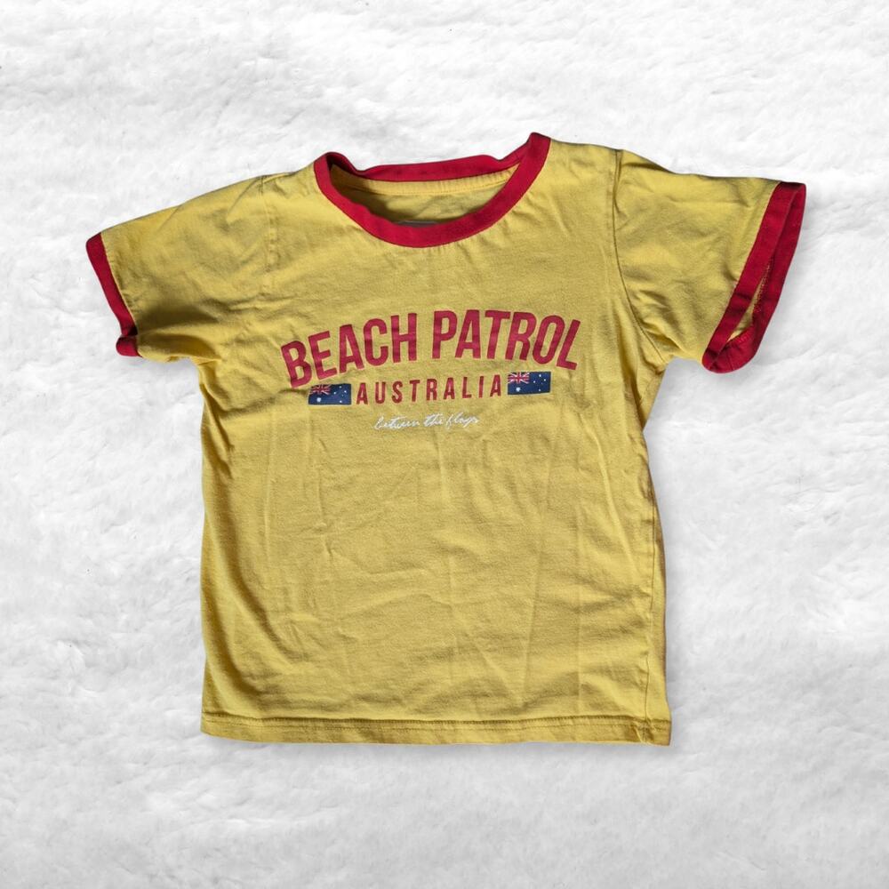 between the flags beach patrol australia contrast baby tee